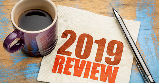 2019 year review text on a napkin with a cup of coffee, end of year business concept