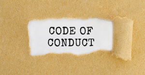 Text Code of Conduct appearing behind ripped brown paper.