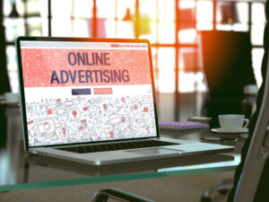 Online Advertising Concept. Closeup Landing Page on Laptop Screen in Doodle Design Style. On Background of Comfortable Working Place in Modern Office. Blurred, Toned Image. 3D Render.-2