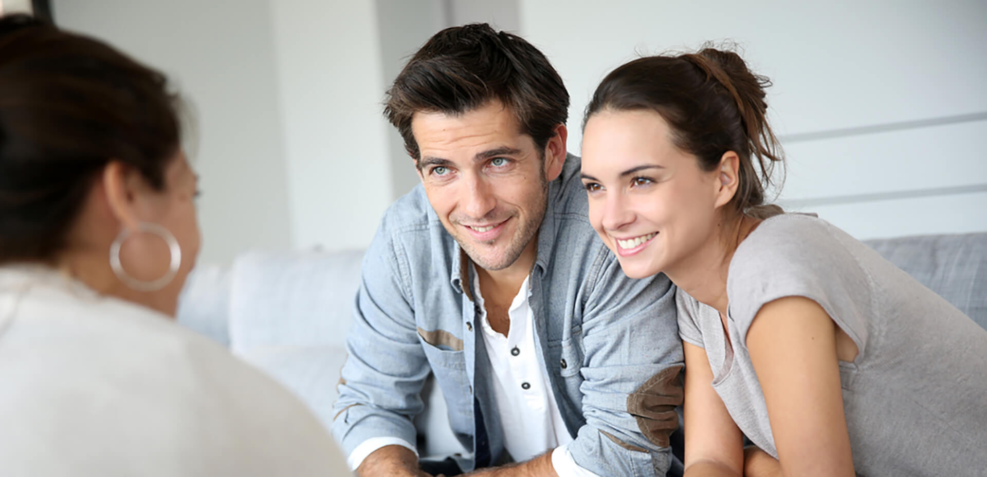 Couple smiling as financial advisor shows them the tax credits and deductions available.