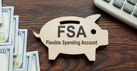 image of a piggy bank with the words "FS Flexible Spending Account" on it. Next to the bank is a calculator and cash
