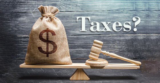 image of a money bag on a double weighted scale with a gavel on the other scale and the text "taxes?" above the image