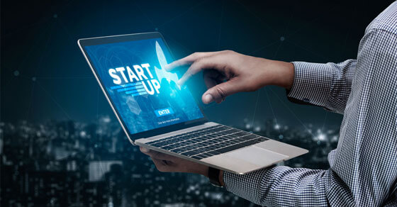 Image of an open laptop with 'Start Up" written on the screen.