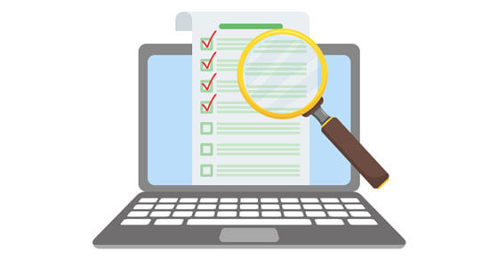Image of a laptop with a magnifying glass on the screen looking at a document with checkmarks.