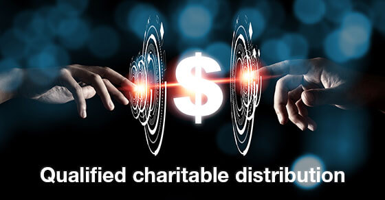 Image of the money symbol inbetween two hands and the text "qualified charitable distribution" along the bottom