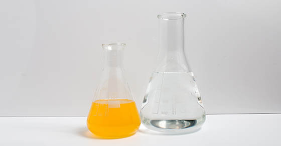 Laboratory glassware filled with chemical liquids on a white background. Science.