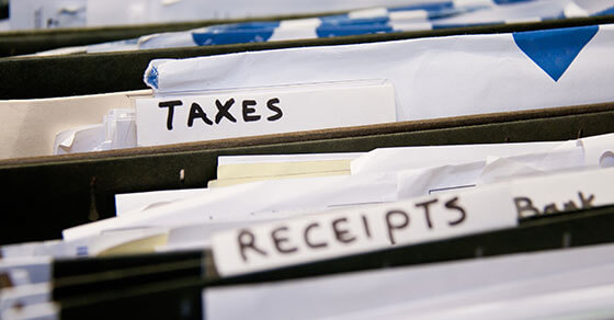 folders in a filing cabinet with tabs reading "taxes", "receipts", etc.
