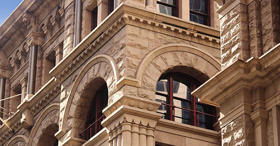 Close up of the architectural detailing of a refurbished heritage sandstone building. Now retail and office space. former headquarters for the American Equitable Life Assurance Society