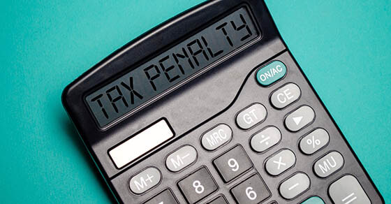 TAX PENALTY word on calculator. Business and tax concept. Time to pay tax in year.