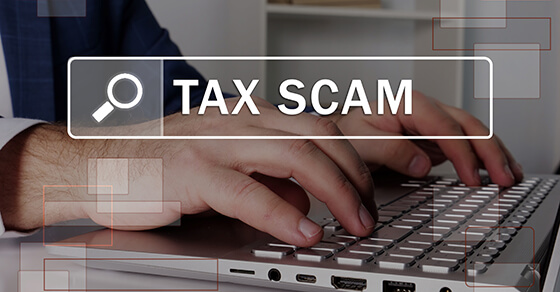 image of a computer keyboard with the words "tax scam" above it.