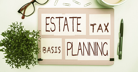 a board on a table with the words "estate tax basis planning" on it.