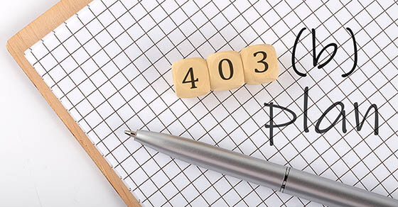 403B PLAN text concept written on wooden cubes blocks and notebook