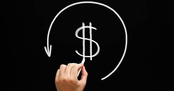 Refund concept dollar sign in arrow circle on blackboard. Compensation paid to a customer for returned goods or for over-invoicing. Return by the taxation authorities of excess tax paid.
