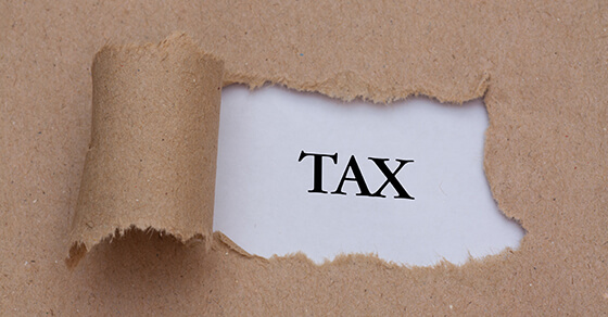 image of a orn opening in a peice of paper showing "tax" written underneigth.