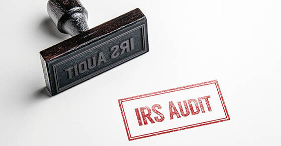 Rubber stamping that says 'IRS Audit'.