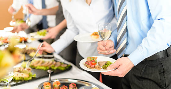 Catering at business company event people choosing buffet food appetizers