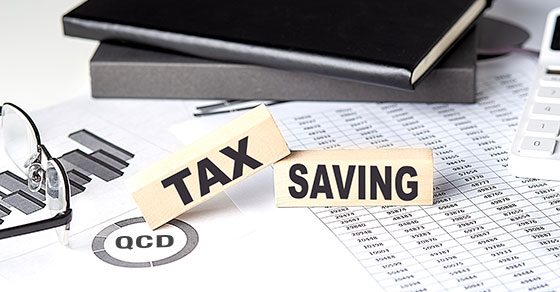 image of documents on a desk with nameplates on top reading "tax" and "saving"